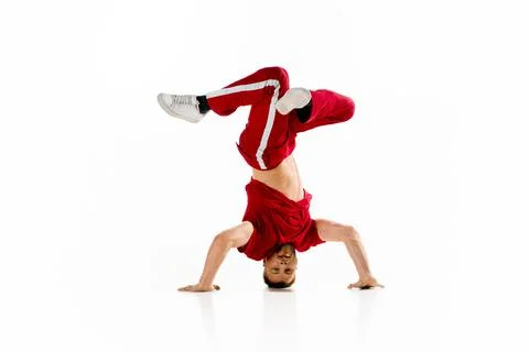 Headspin. Stylishly dressed man dancing breakdance, freestyle elements standing Stock Photos
