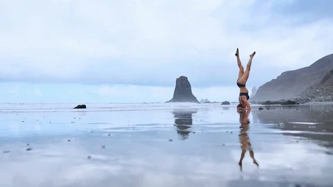 Headstand at the beach Stock Footage 98295573