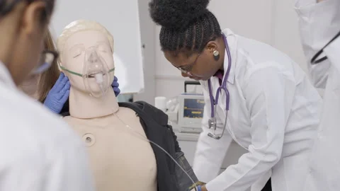 Healing hands: foreign students practicing first aid on mannequin Video stock 275367881