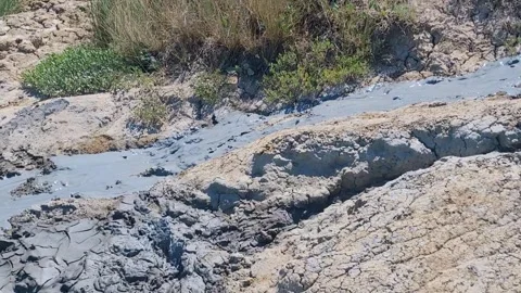 Healing mud flows beautifully like a stream. Mud volcano Hephaestus. Therapeutic Stock Footage 301451814