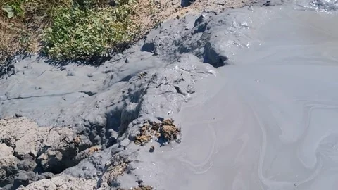 Healing mud flows beautifully like a stream from the crater. Mud volcano Hephaes Stock Footage 301466873