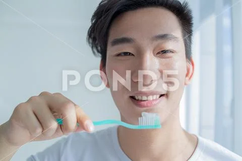 Health And Beauty Concept - Smiling Young Man With Toothbrush