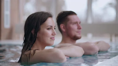 Health and relax, man and woman are resting in thermal bath in wellness center Stock Footage