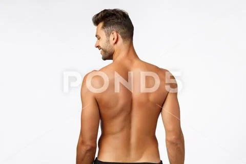Health, bodybuilding and fitness concept. Rear view, handsome confident young Stock Photos