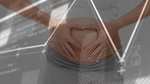 As health graphs and code animating, woman forming heart gesture at abdomen Vidéo 317465842