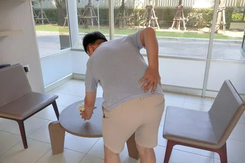 Health problems Man has lower backache from office syndrome, muscle inflammation Stock Photos