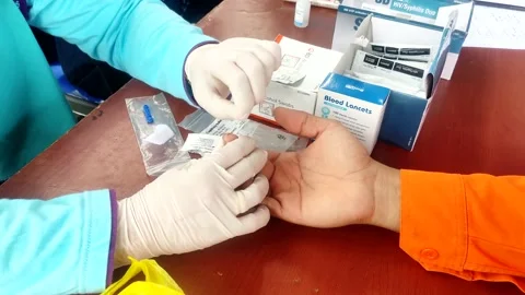 A health worker performs a finger prick test for HIV Stock Footage 209151530