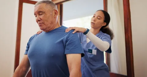 An elderly man getting a back massage, Stock image