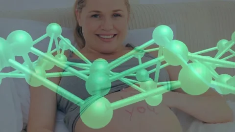Healthcare tech materializing 3D molecular orbiting expectant mother in bed Stock Footage 328458310