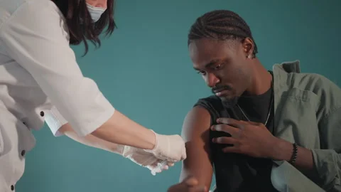 Healthcare worker provides community immunization. Healthcare provider calmly 動画素材 346558151