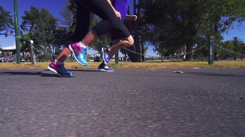 Healthy &amp; active couple running / jogging in slow motion on a road Stock Footage 132241532