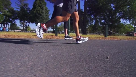 Healthy &amp; active couple running / jogging in slow motion on a road Stock Footage 132241744