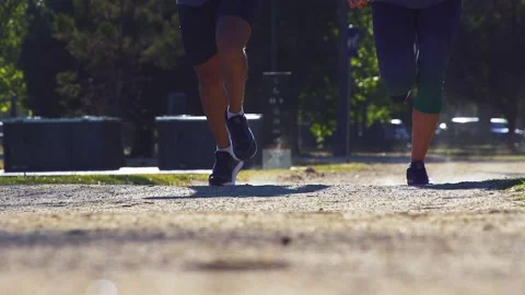 Healthy &amp; active couple running / jogging in slow motion towards camera Stock Footage 132241849