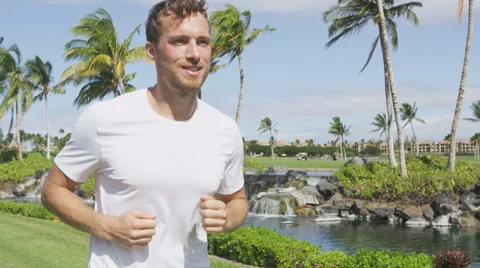 Healthy active man runner running in tropical park - male jogger jogging Stock Footage 48556559