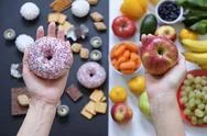 Healthy And Unhealthy Food Concept, Apple And Donut In Hand. Top View Stock Photos