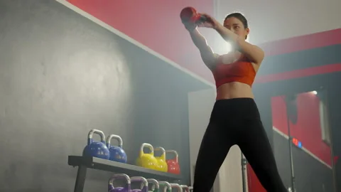 Healthy asian female have sweaty exercising with squat and  lift up kettlebell Stock Footage