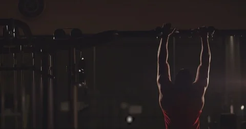 Healthy athlete man training pull ups exercise enjoying intense fitness workout Stock Footage 123278919