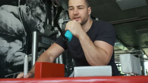 A healthy athlete trains on an exercise machine in the gym and prepares for Video stock 135969668