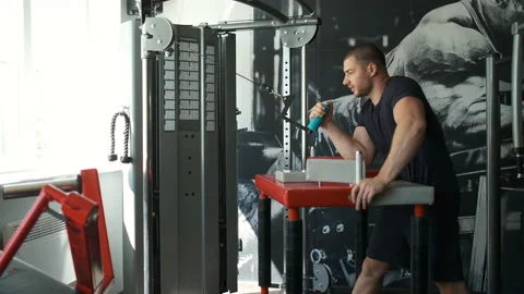 A healthy athlete trains on an exercise machine in the gym and prepares for Stock Footage 135970788