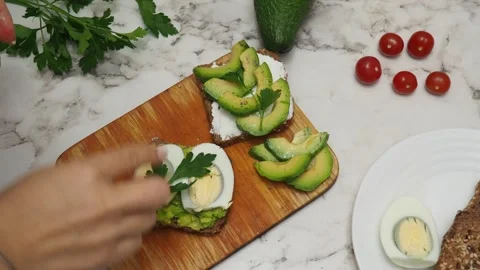 Healthy avocado toasts with rye bread, sliced avocado, eggs, cottage Stock Footage 272158198