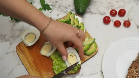 Healthy avocado toasts with rye bread, sliced avocado, eggs, cottage Stock Footage 272158239