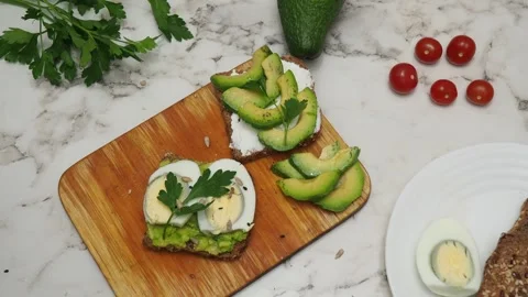 Healthy avocado toasts with rye bread, sliced avocado, eggs, cottage Stock Footage 272158683