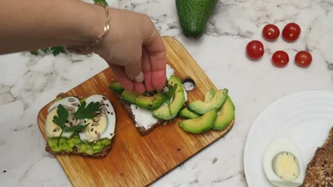 Healthy avocado toasts with rye bread, sliced avocado, eggs, cottage Stock Footage 272158754