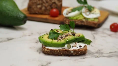 Healthy avocado toasts with rye bread, sliced avocado, eggs, cottage Stock Footage 272158907