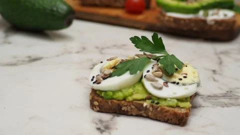 Healthy avocado toasts with rye bread, sliced avocado, eggs, cottage Stock Footage 272158908