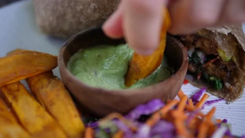 Healthy balanced lunch option. Close up of hand dipping potato chip in mayo and Stock-Footage 146363225
