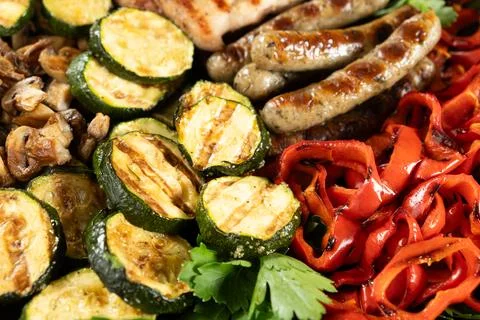 Healthy BBQ platter featuring roasted corn, zucchini and poultry Stock Photos