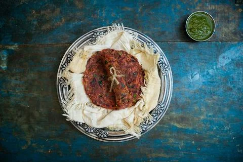 Healthy Beetroot Flatbread or Paratha in a silver plate with green chutney. 写真素材