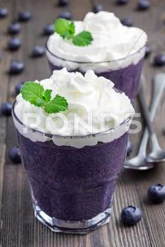 Healthy boiled egg blueberry mousse with whipping cream in glass Stock Photos