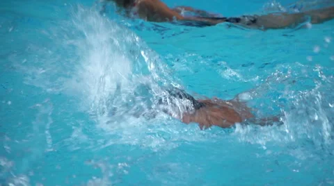 Healthy boy butterfly stroke swims slow motion in swimming pool Stock Footage