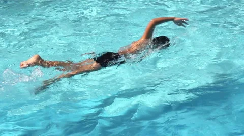 Healthy boy front crawl swims in swimming pool Video stock 63249235
