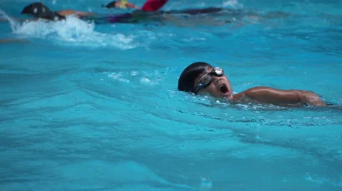 Healthy boy front crawl swims slow motion in swimming pool Stock Footage 68024231