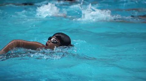 Healthy boy front crawl swims slow motion in swimming pool Stock Footage 68024673