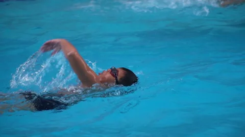 Healthy boy front crawl swims slow motion in swimming pool Stock Footage 68026340