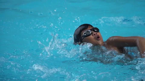 Healthy boy front crawl swims slow motion in swimming pool Stock Footage 68027063