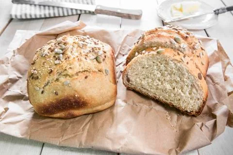 Healthy bread over a white rustic wooden table. Stock Photos