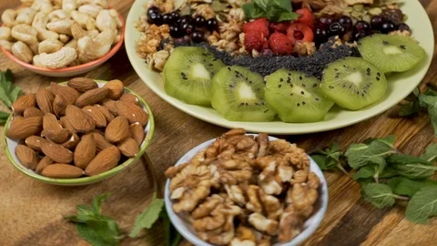 Healthy Breakfast Bowls. Nuts, Smoothies, Muesli, Seeds, Fresh Fruit. Clean Food Stock Footage