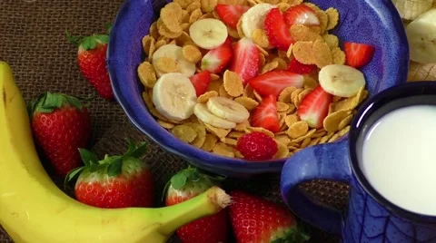 Healthy breakfast. Cornflakes, fresh strawberries, banana and milk Video stock 59186584