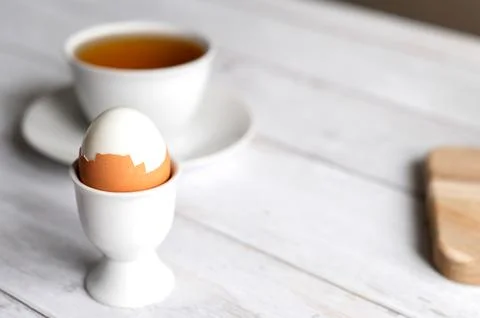 Healthy breakfast with egg and tea. Clean eating concept with copy space. Stock Photos