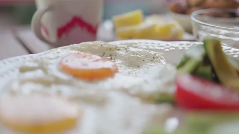 Healthy breakfast with fried eggs, vegetables, fruit, dairy and nuts on table Stock Footage 194509530