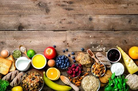 Healthy breakfast ingredients, food frame. Granola, egg, nuts, fruits, berries Stock Photos