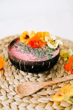 Healthy Breakfast in a plate of coconut and bamboo spoon with nasturtium flow Stock Photos