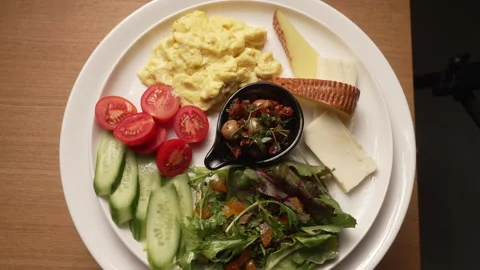 Healthy breakfast plate with eggs, cheese, and fresh vegetables Stock Footage 336742590