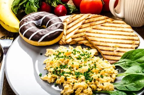 Healthy breakfast scrambled eggs with chive panini toast Stock Photos