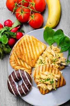 Healthy breakfast scrambled eggs with chive panini toast Stock Photos
