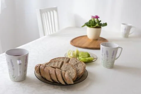 Healthy Breakfast Setting on White Table with Spring Flowers Stock Photos